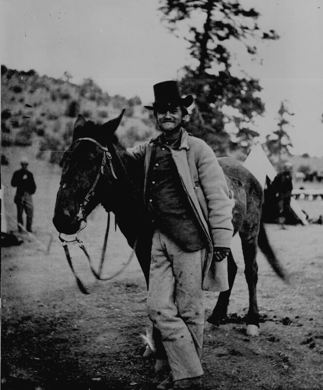 "Fred W. Loring, in his campaign costume, with his mule `Evil Merodach.' Taken about 48 hours before he was brutally murdered by Yapavi Indians, while en route from Prescott, A. T. [Ariz. Terr.] to San Bernadino, Cal., by stage. Loring had been with